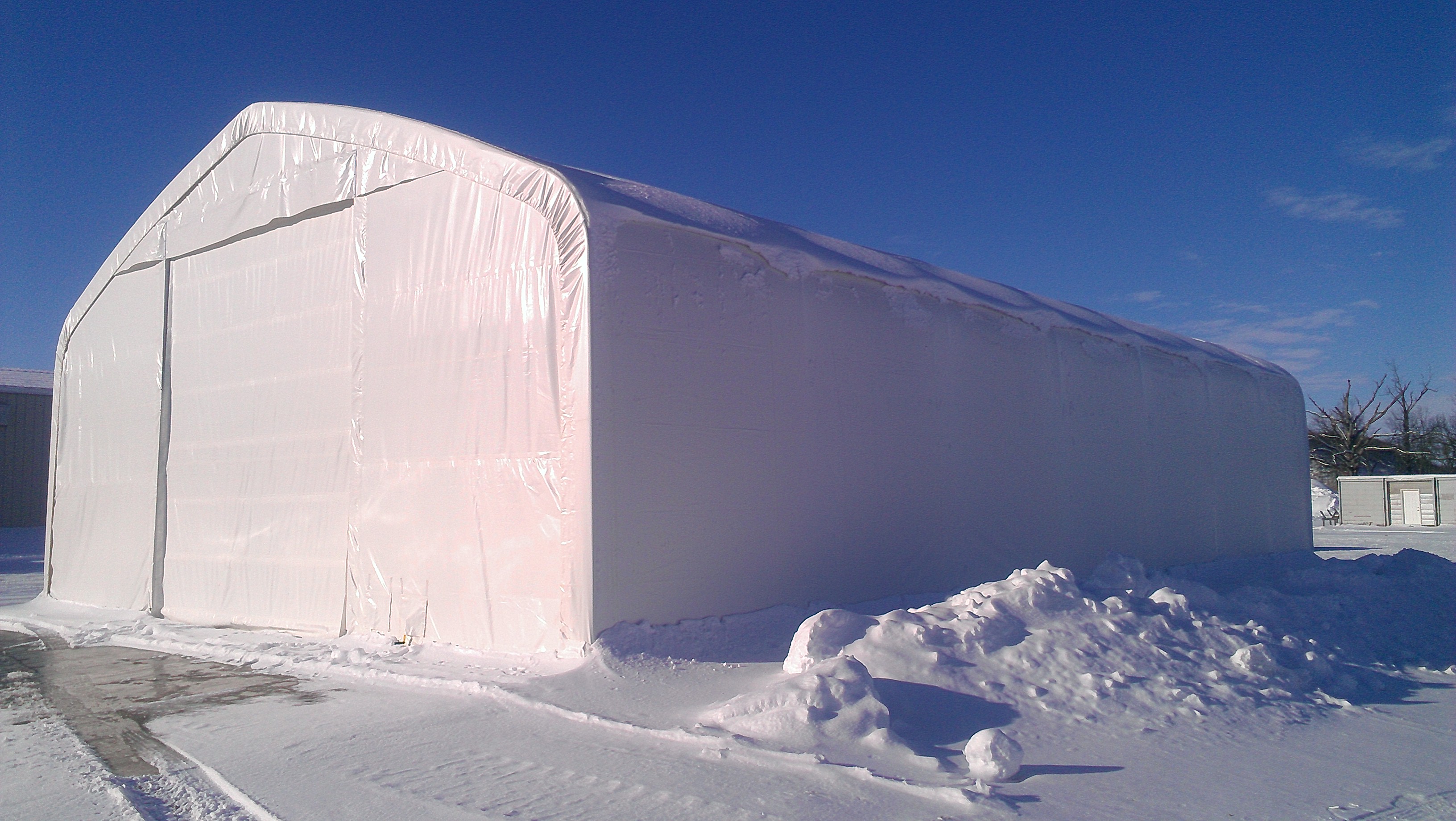 Crestline tent structure tent seetup outdoors in winter snow for storage and maintenance