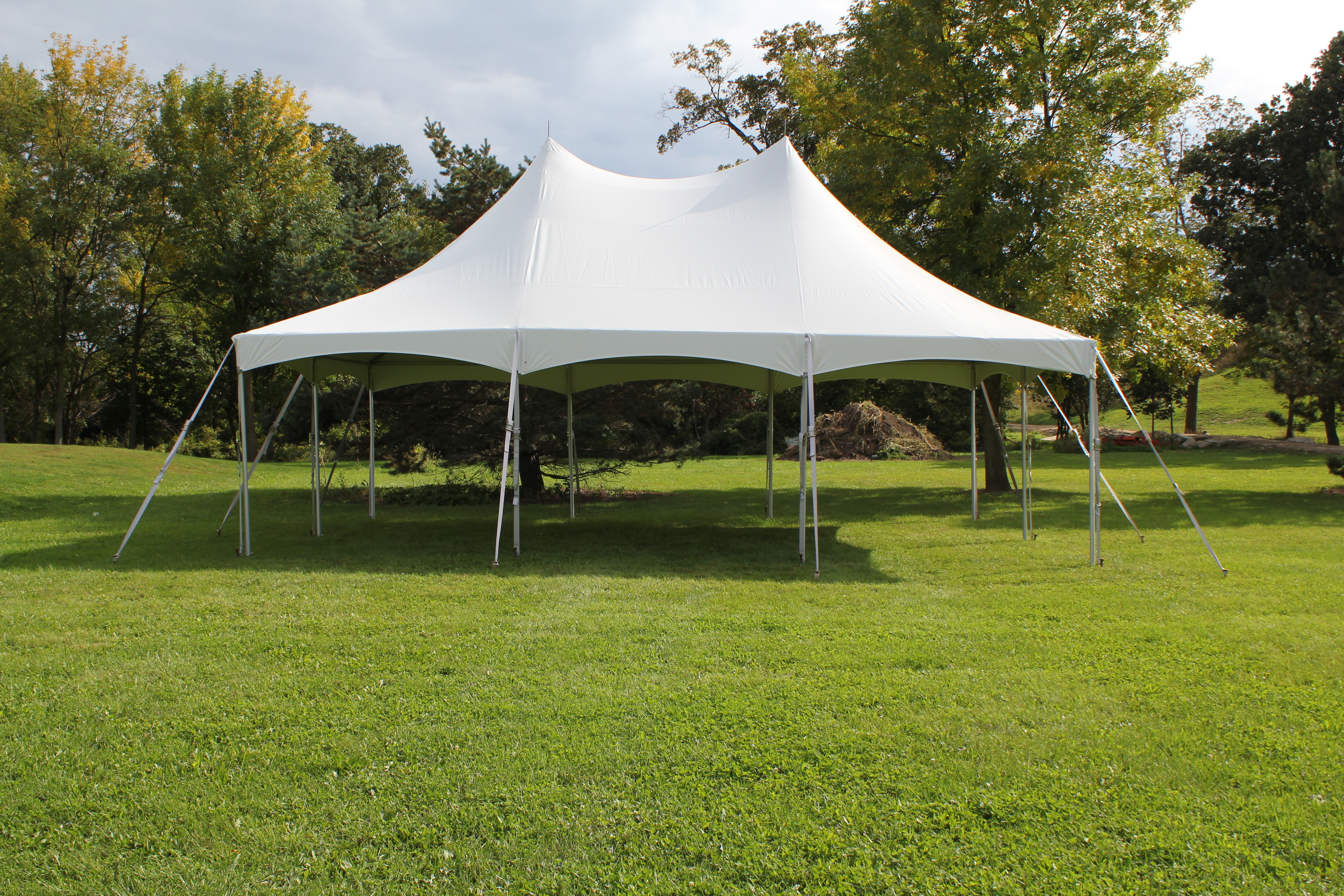 White 20x30 master series high peak tent setup for outdoor event