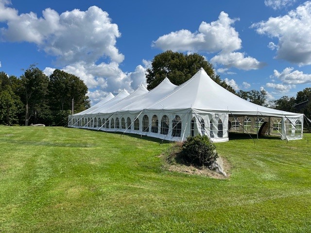 White premiere high peak pole party tent setup for event with window sidewalls