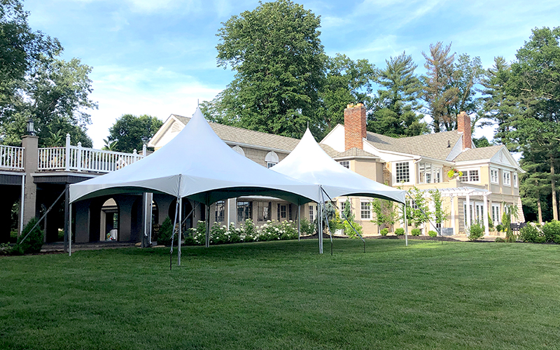 An event pinnacle tent setup for an elegant backyard gathering