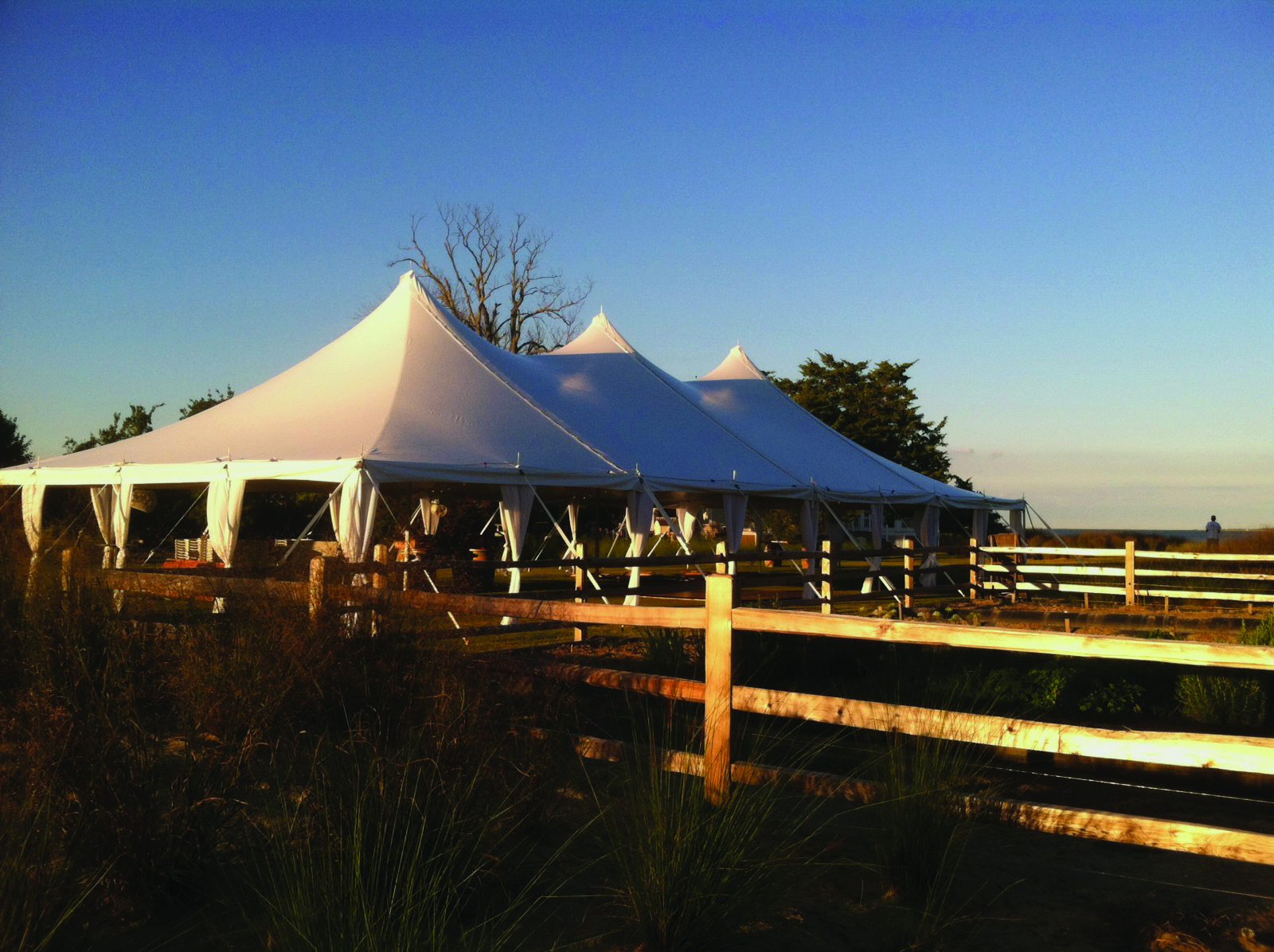 Elegant outdoor wedding high peak tent setup with leg drapes 