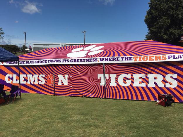 Custom-printed team tent providing shade at a summer sports event