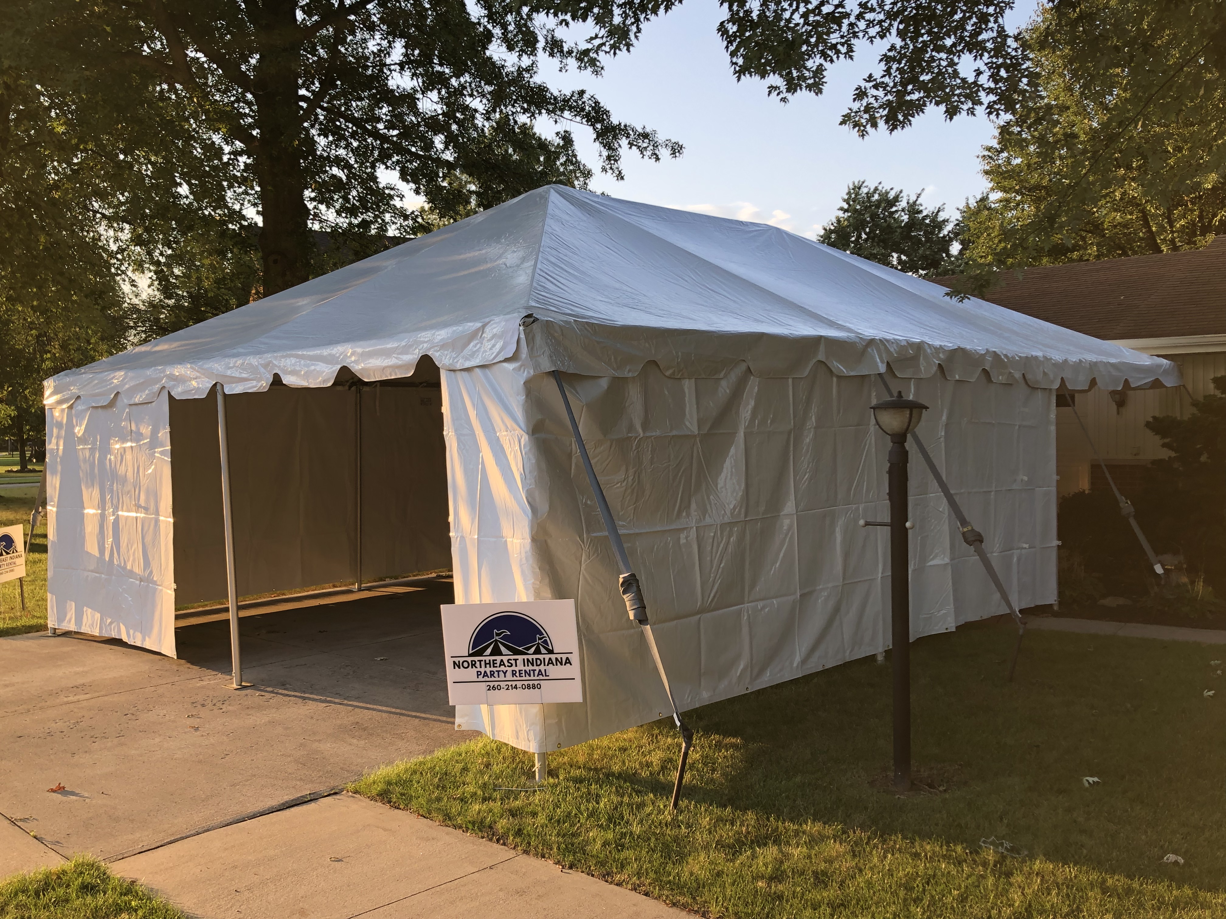 Vinyl party frame tent setup with sidewalls for an outdoor event