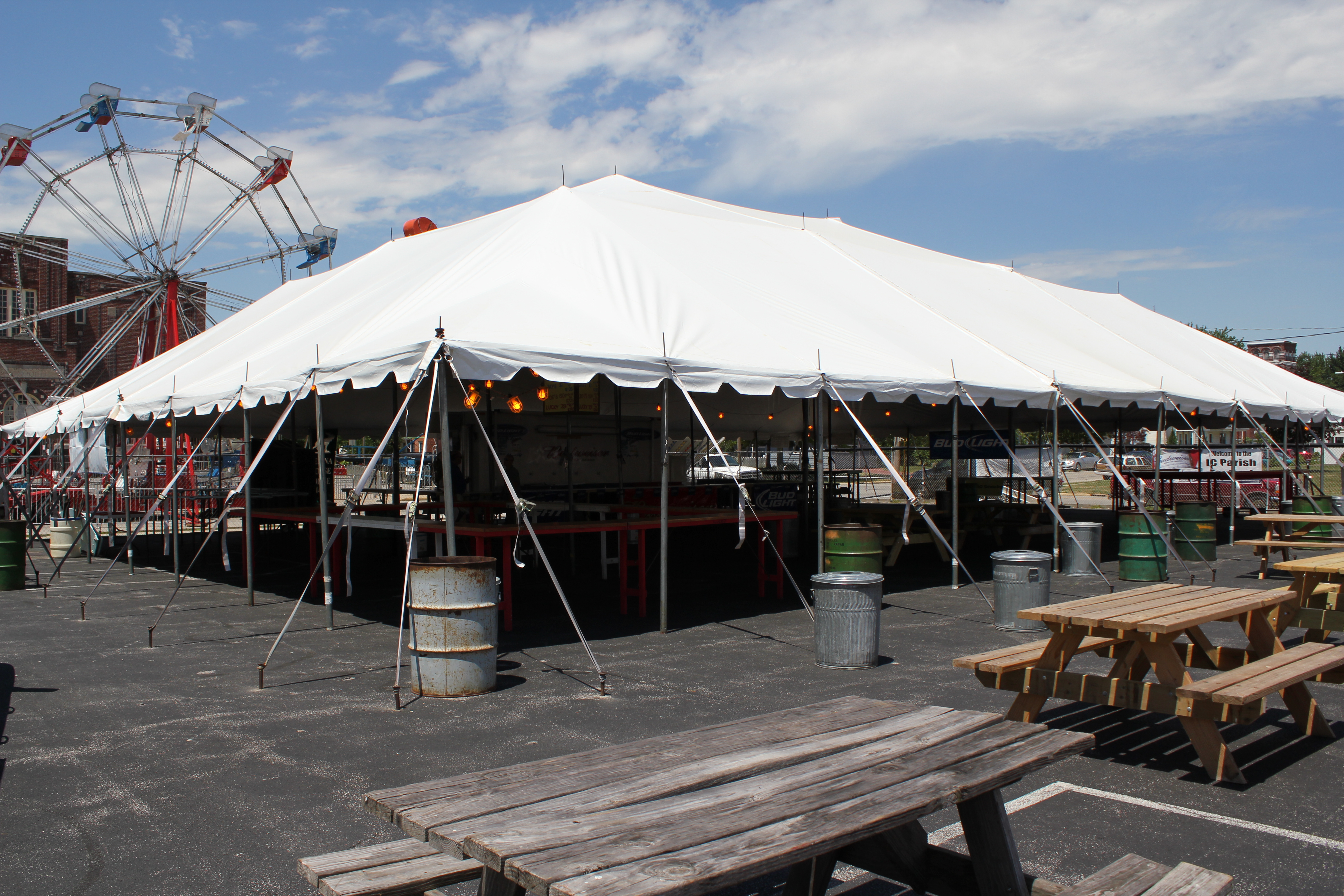 Pole tent anchored into asphalt