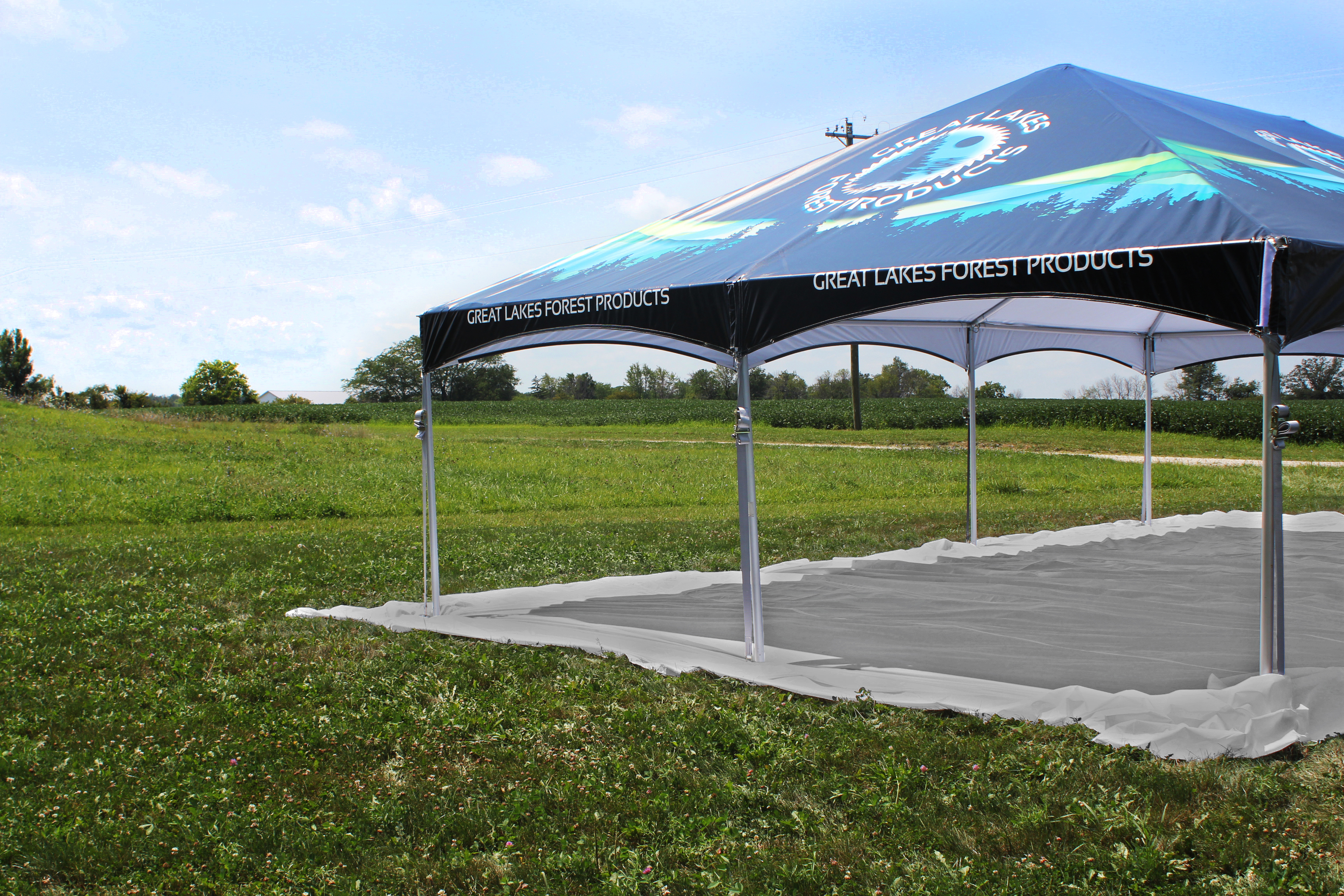 Drop cloth setup under custom printed master series frame tent