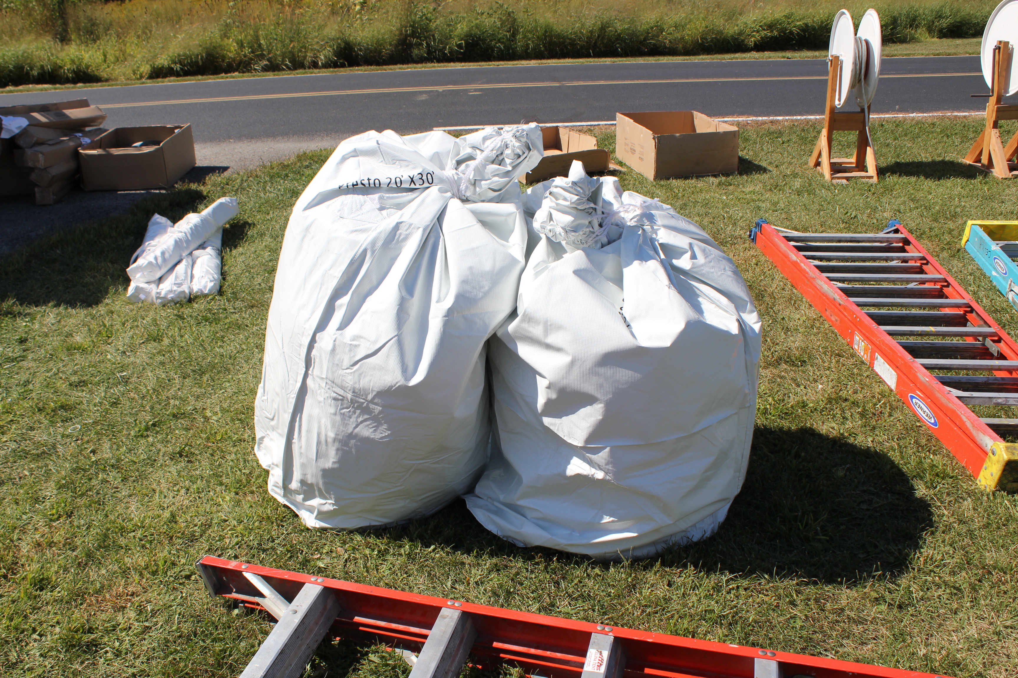 Tent bags and installation materials laying out at site