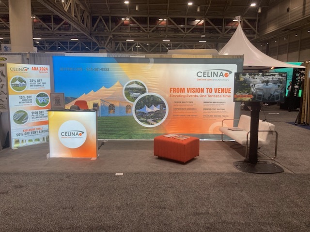 Convention booth setup with printed tent and branding materials