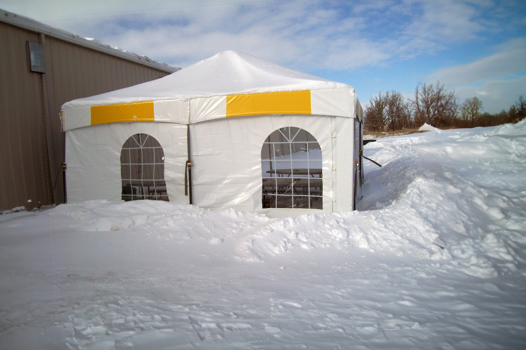 Master series frame tent setup in the snow with cathedral window sidewalls