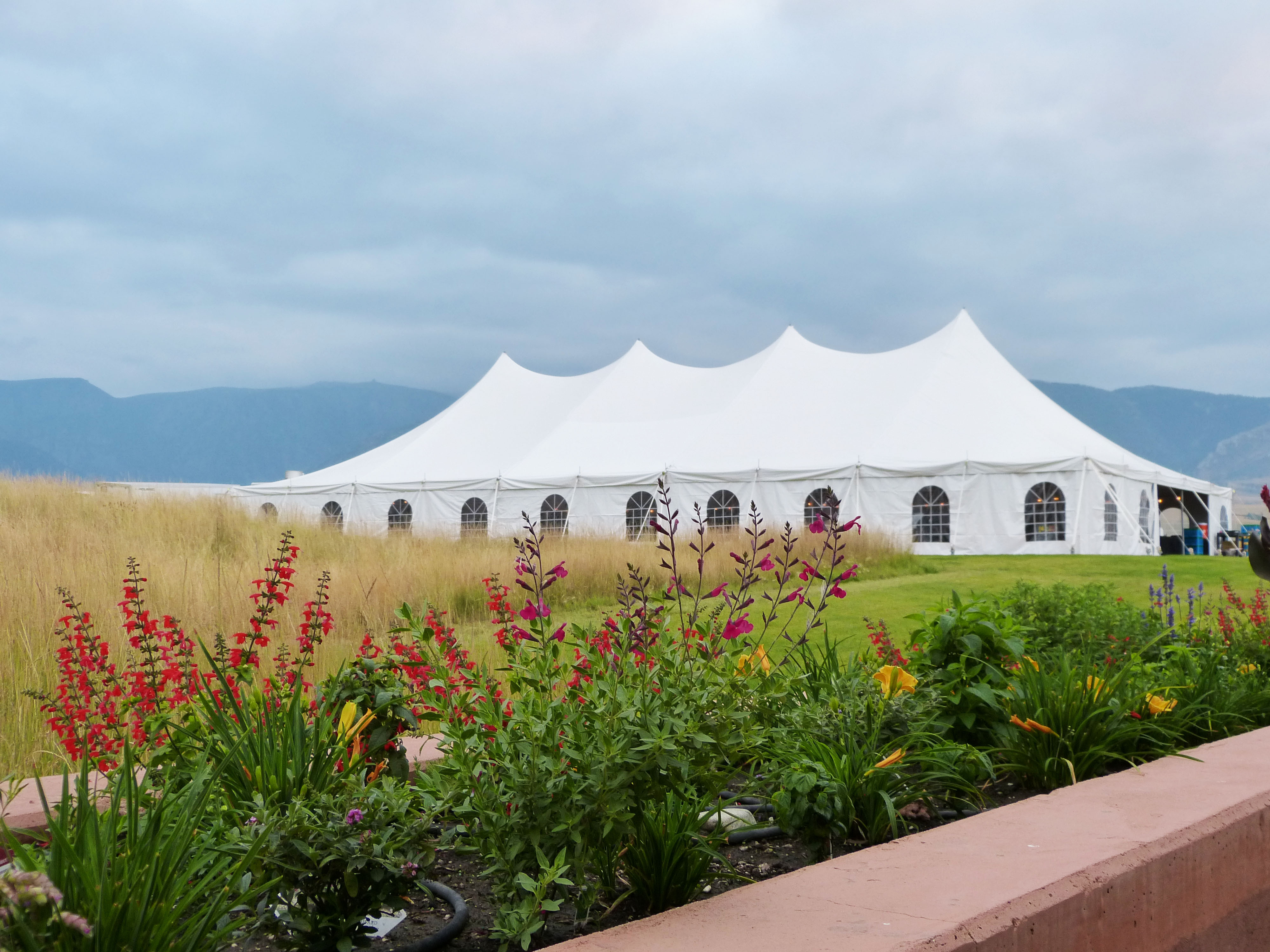 Premiere high peak party tent setup with spring flowers