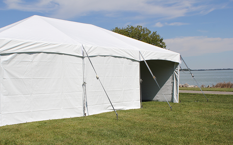 Outdoor event tent with sidewalls providing protection from wind and rain.