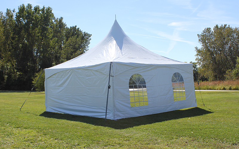 White event tent with window sidewalls showcasing a scenic outdoor view